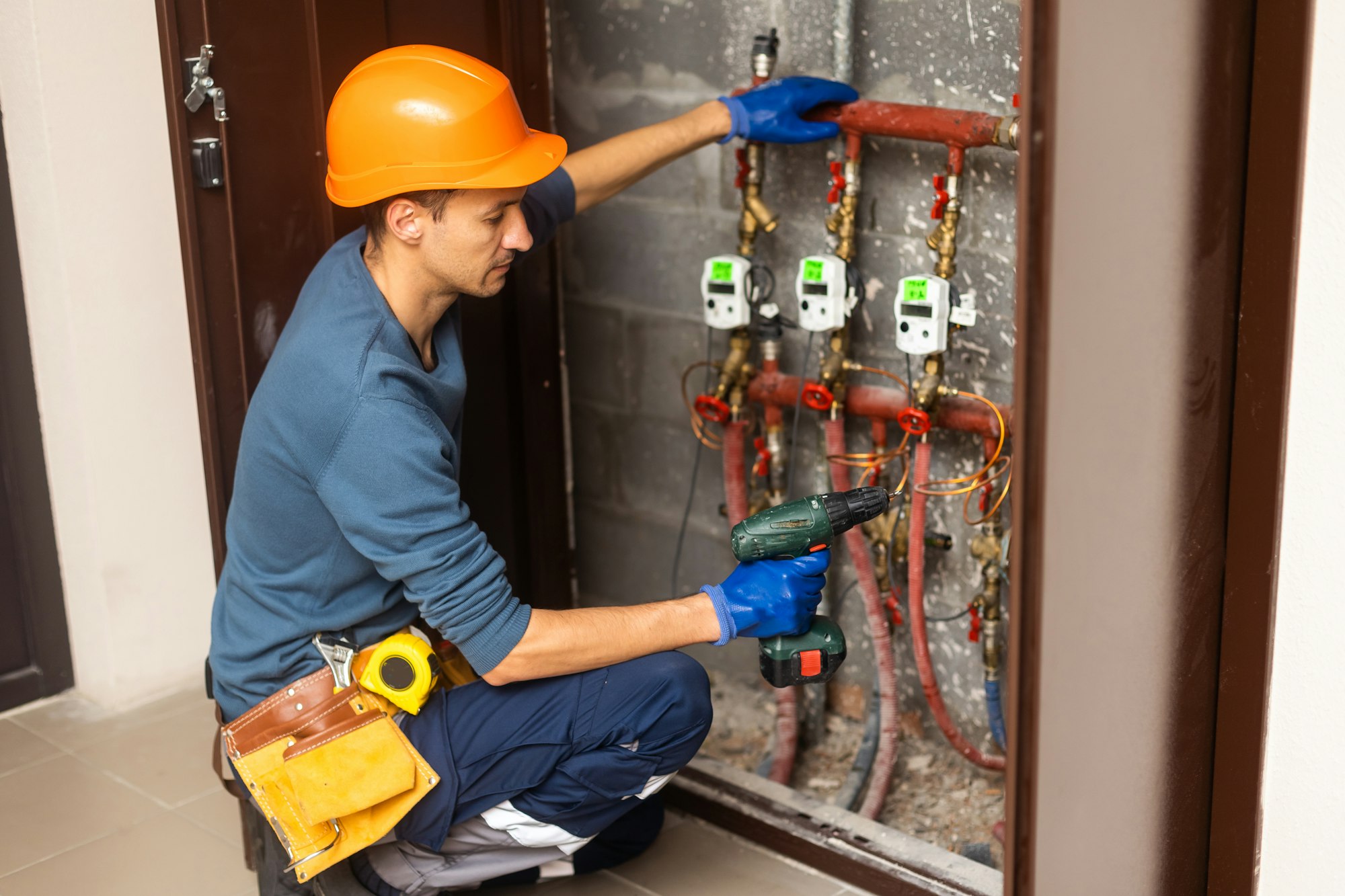 plumber installing pressure meter for house heating system