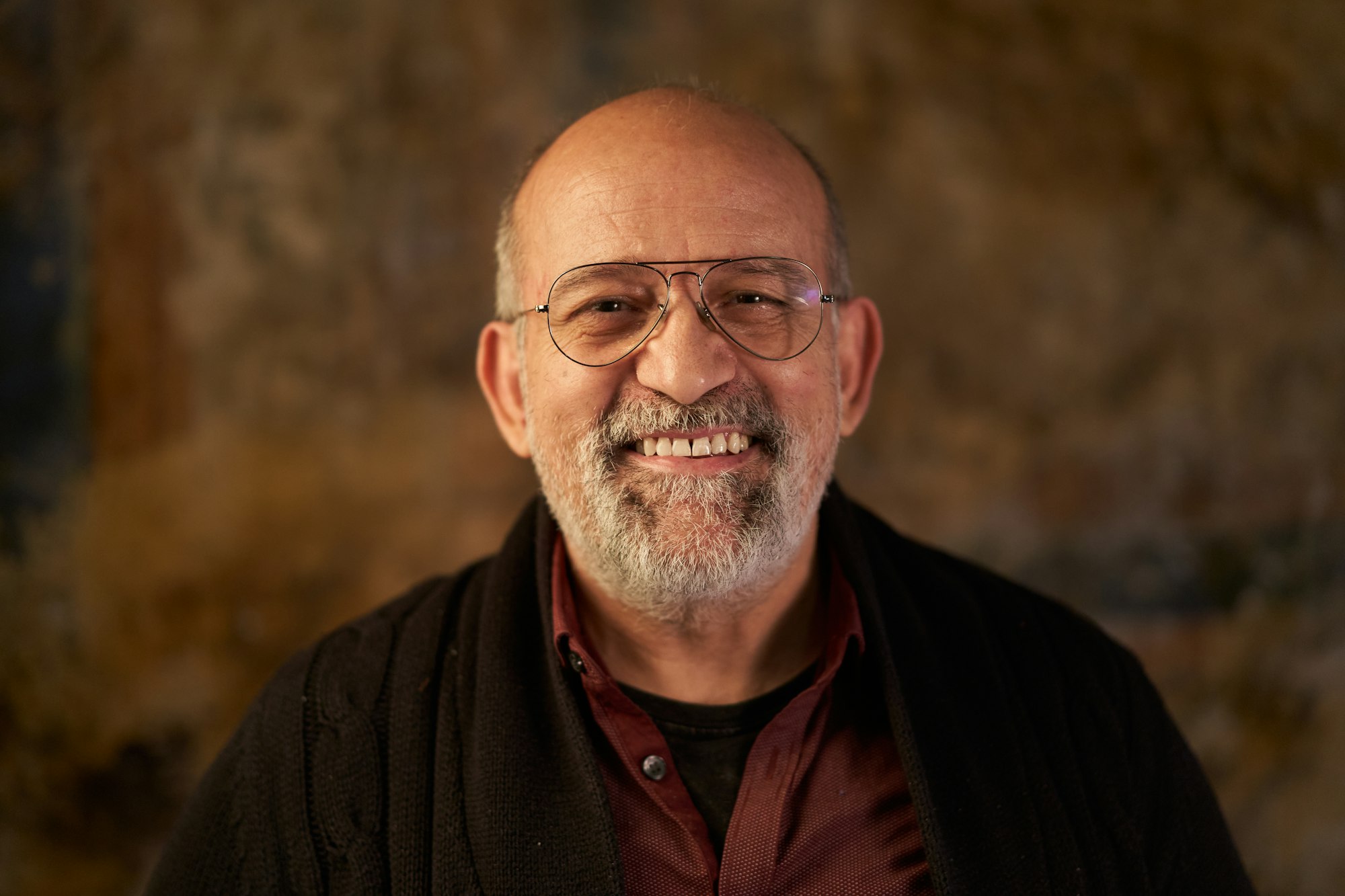 Portrait of a middle-aged Caucasian smiling man looking at camera. Look of an older person